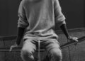 a man sitting on a wall