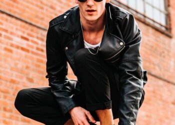 A man is sitting on a wall