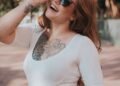 A girl is smiling on a street