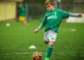 little boy playing football