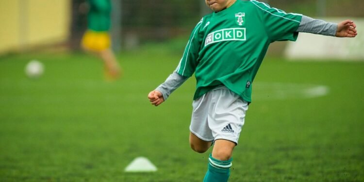 little boy playing football